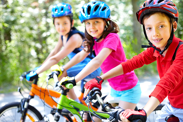 Group of Three Children Riding Bikes Together
