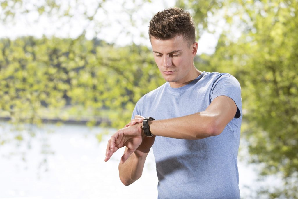 Man checking a fitness tracker watch