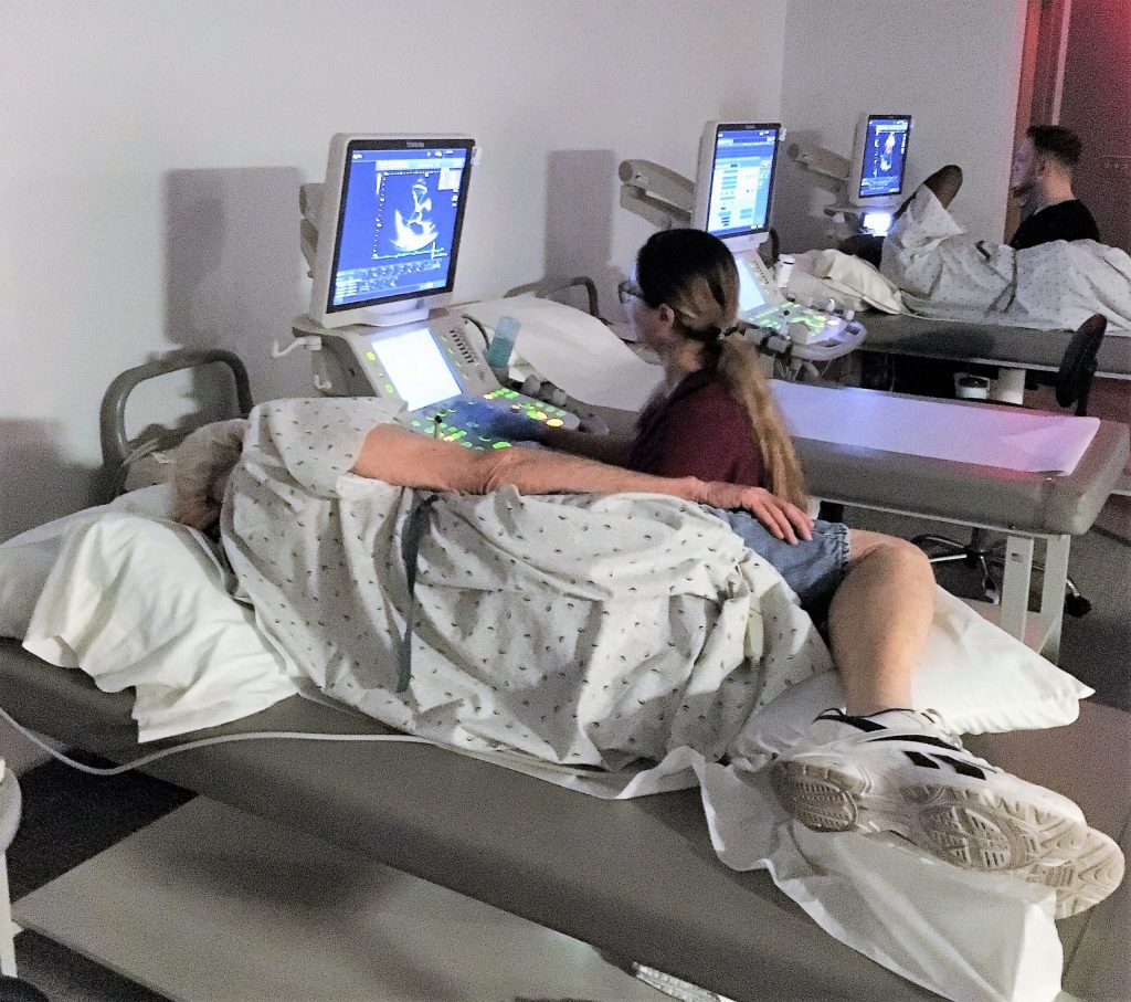 Ultrasound Sonographer Student scanning man