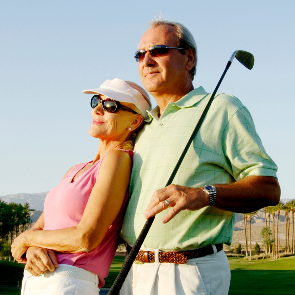 man and woman both wearing sunglasses while golfing