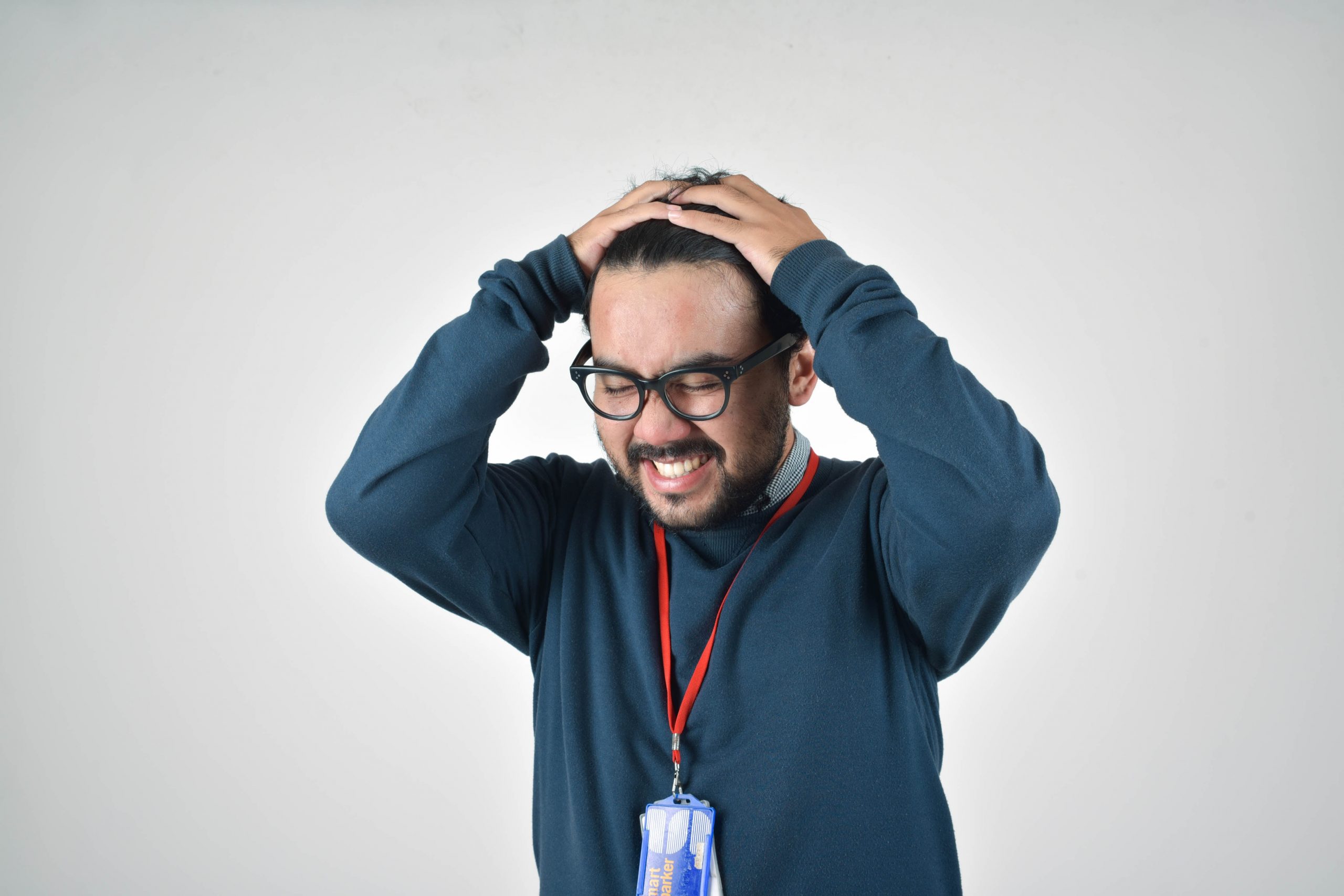 stressed man with his hands on his head