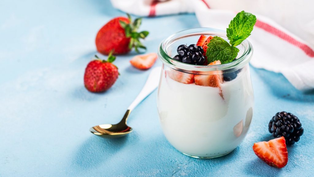 Greek yogurt in a glass with berries on top